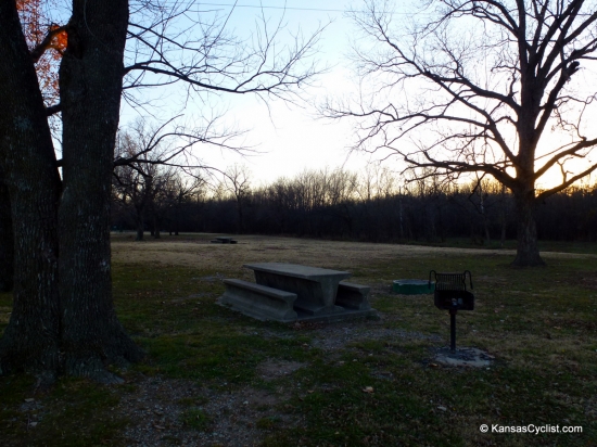 Baxter Springs Riverside Park - Campsite - This is a typical campsite at Baxter Springs Riverside Park, with a concrete picnic table, grill, and fire ring.