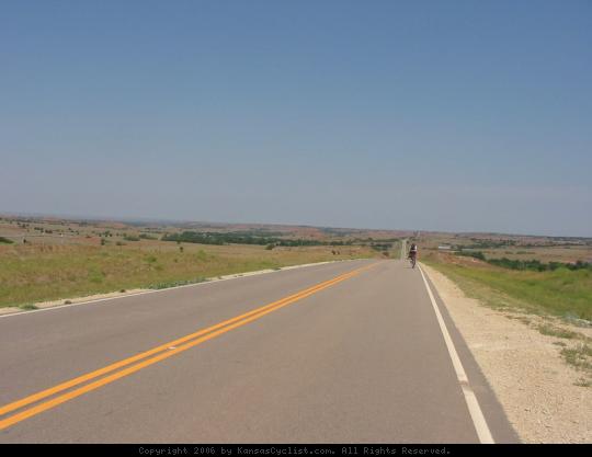 Biking Across Kansas 2006 - A cyclist pedals through the Gypsum Hills on Hwy 160 west of Medicine Lodge.