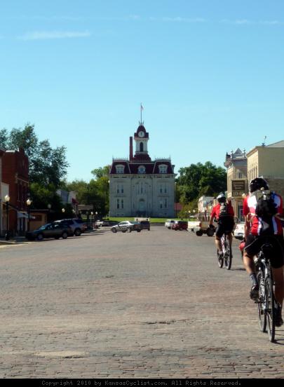 Bicyclists in Cottonwood Falls, Kansas - A groups of bicyclists ride the brick streets towards the historic courthouse in Cottonwood Falls, Kansas.