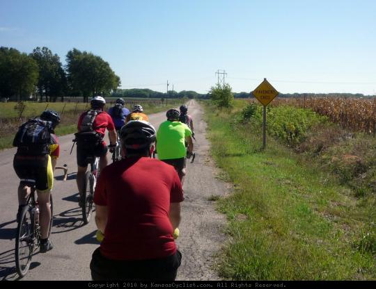 Pavement Ends - A groups of bicyclists contemplate the end of the pavement and the start of a gravel road in Chase County, Kansas.