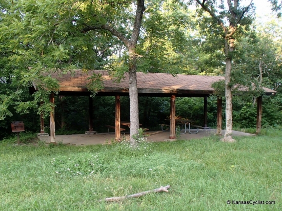 Old Military Trail Campground - Shelter - This is the shelter at the Old Military Trail Campground at Perry Lake. It includes picnic tables, a grill, and fire ring. There is grass nearby, and along the access road, for tenting.